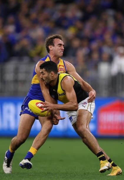 Luke Edwards of the Eagles tackles Marlion Pickett of the Tigers during the round 14 AFL match between the West Coast Eagles and the Richmond Tigers...