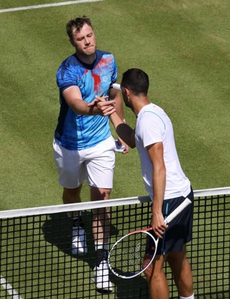 Illya Marchenko of Ukraine shakes hands with James Ward of Great Britain after winning their Men's Singles Qualifying match at the cinch...