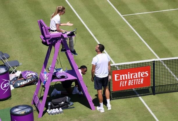 James Ward of Great Britain talks to umpire Raluca Alexandra Andrei during his Men's Singles Qualifying match against Illya Marchenko of Ukraine at...