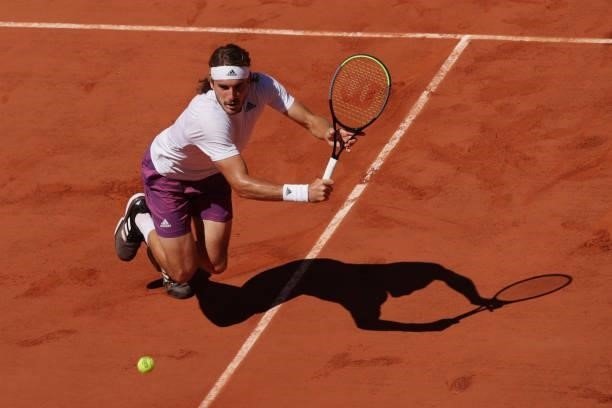 Stefanos Tsitsipas of Greece stretches to play a backhand in his Men's Singles Final match against Novak Djokovic of Serbia during Day Fifteen of the...