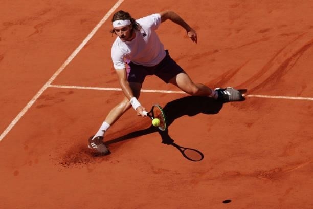 Stefanos Tsitsipas of Greece stretches to play a forehand in his Men's Singles Final match against Novak Djokovic of Serbia during Day Fifteen of the...