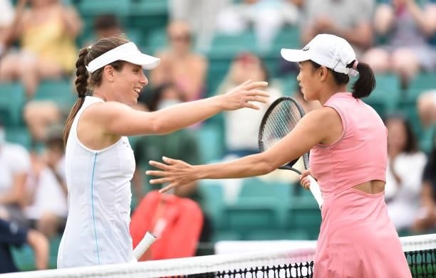 Johanna Konta of Great Britain is congratulated by Shuai Zhang of China after she wins the women's singles match at Nottingham Tennis Centre on June...