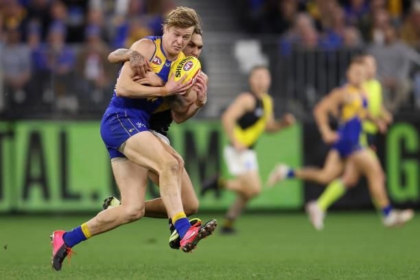 Shai Bolton of the Tigers tackles Jackson Nelson of the Eagles during the round 14 AFL match between the West Coast Eagles and the Richmond Tigers at...