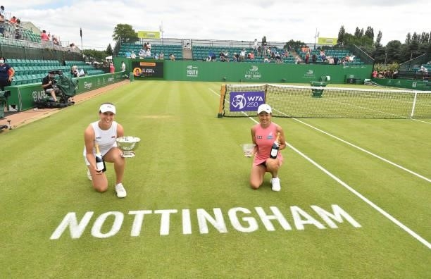 Johanna Konta of Great Britain holds the Viking Women's singles trophy and Shuai Zhang of China holds winners up trophy after the women's singles...