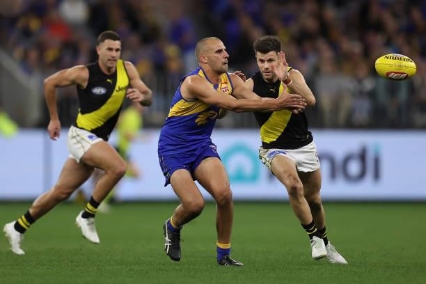 Dom Sheed of the Eagles handballs during the round 14 AFL match between the West Coast Eagles and the Richmond Tigers at Optus Stadium on June 13,...