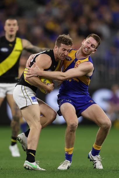 Luke Foley of the Eagles tackles Kane Lambert of the Tigers during the round 14 AFL match between the West Coast Eagles and the Richmond Tigers at...