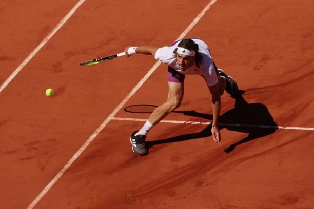 Stefanos Tsitsipas of Greece stretches to play a shot in his Men's Singles Final match against Novak Djokovic of Serbia during Day Fifteen of the...
