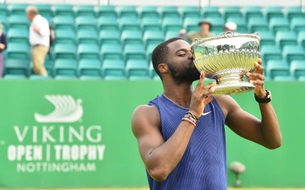 Frances Tafore of United States kisses the Mens Singles Vikings Open Trophy after he beats Denis Kudla of United States at Nottingham Tennis Centre...