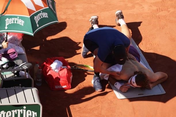 Stefanos Tsitsipas of Greece receives medical treatment on court after the third set in his Men's Singles Final match against Novak Djokovic of...