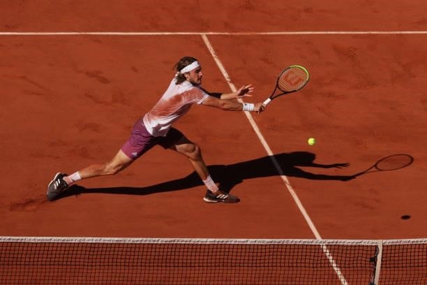 Stefanos Tsitsipas of Greece stretches to play a backhand in his Men's Singles Final match against Novak Djokovic of Serbia during Day Fifteen of the...