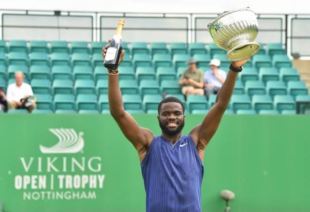 Frances Tafore of United States holds the Mens Singles Vikings Open Trophy during the men’s final match against Denis Kudla of United States at...