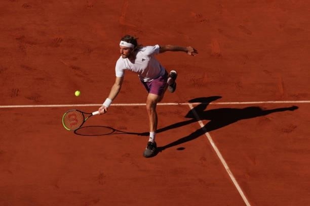 Stefanos Tsitsipas of Greece stretches to play a forehand in his Men's Singles Final match against Novak Djokovic of Serbia during Day Fifteen of the...
