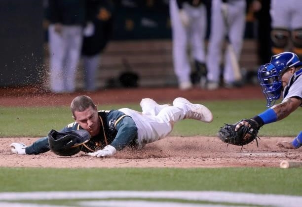 Matt Chapman of the Oakland Athletics scores the winning run on a walk-off RBI single from Elvis Andrus to defeat the Kansas City Royals 4-3 in the...
