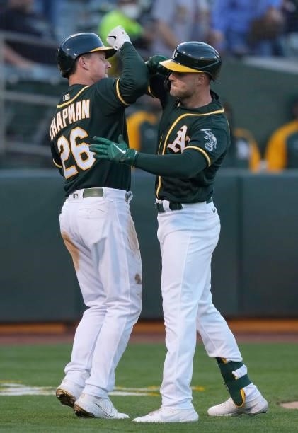 Seth Brown and Matt Chapman of the Oakland Athletics celebrates after Brown hit a two-run home run against the Kansas City Royals in the bottom of...