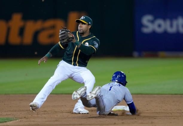 Jarrod Dyson of the Kansas City Royals steaks second base sliding in ahead of the tag from Elvis Andrus of the Oakland Athletics in the top of the...