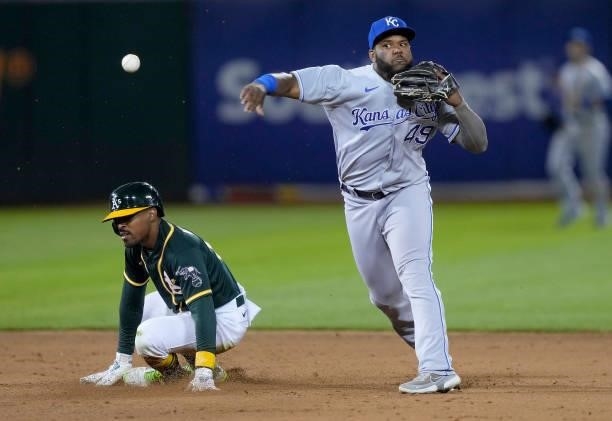 Hanser Alberto of the Kansas City Royals completes the double-play throwing over the top of Tony Kemp of the Oakland Athletics in the bottom of the...