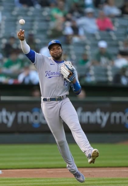 Kelvin Gutierrez of the Kansas City Royals throw off balance to first base throwing out Jed Lowrie of the Oakland Athletics in the bottom of the...