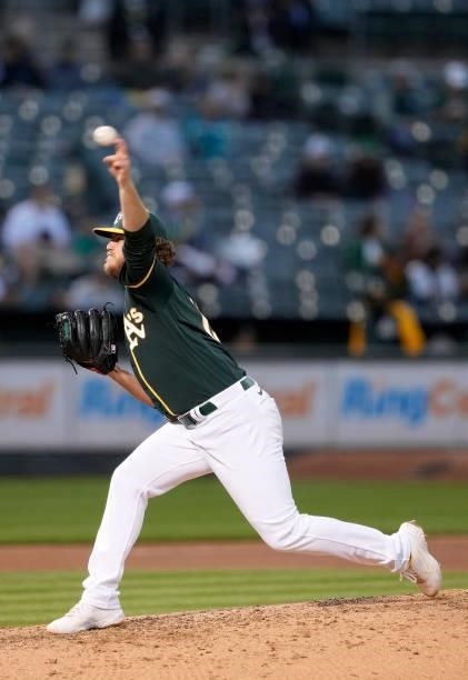 Cole Irvin of the Oakland Athletics pitches against the Kansas City Royals in the top of the seventh inning at RingCentral Coliseum on June 11, 2021...