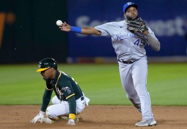 Hanser Alberto of the Kansas City Royals completes the double-play throwing over the top of Tony Kemp of the Oakland Athletics in the bottom of the...