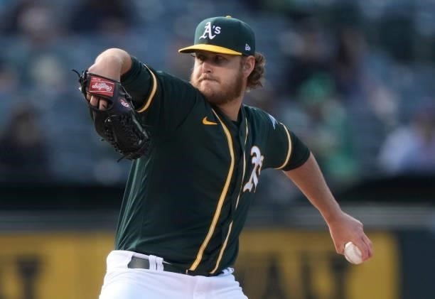 Cole Irvin of the Oakland Athletics pitches against the Kansas City Royals in the top of the first inning at RingCentral Coliseum on June 11, 2021 in...