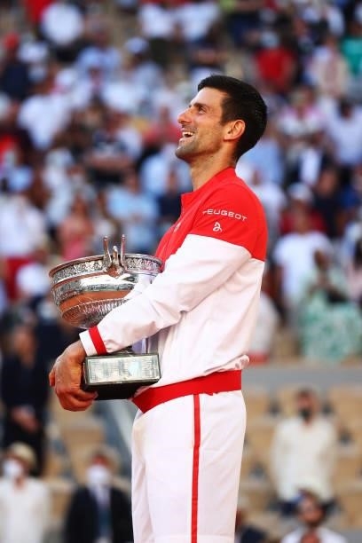 Novak Djokovic of Serbia celebrates as he holds the trophy after winning his Men's Singles Final match against Stefanos Tsitsipas of Greece during...