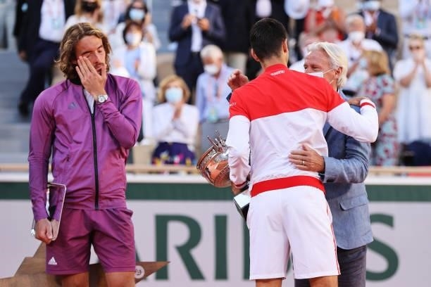Novak Djokovic of Serbia embraces former tennis player Bjorn Borg as receives the trophy after winning his Men's Singles Final match against Stefanos...