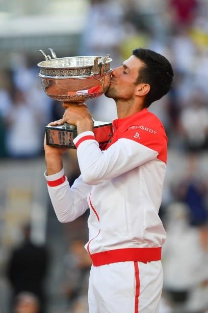 Novak Djokovic of Serbia celebrates as he kisses the trophy after winning his Men's Singles Final match against Stefanos Tsitsipas of Greece during...