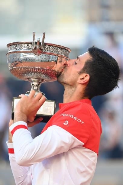 Novak Djokovic of Serbia celebrates as he kisses the trophy after winning his Men's Singles Final match against Stefanos Tsitsipas of Greece during...