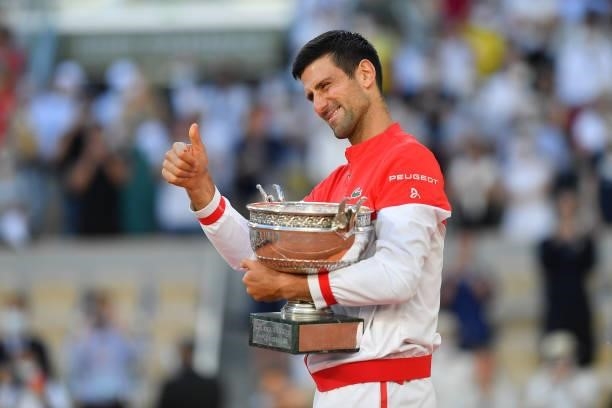Novak Djokovic of Serbia celebrates with the trophy after winning his Men's Singles Final match against Stefanos Tsitsipas of Greece during Day...