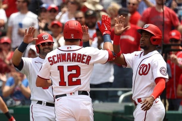 Kyle Schwarber of the Washington Nationals celebrates with Alex Avila and Victor Robles after hitting a three RBI home run against the San Francisco...