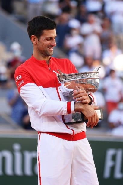 Novak Djokovic of Serbia celebrates as he holds the trophy after winning his Men's Singles Final match against Stefanos Tsitsipas of Greece during...