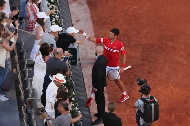 Tournament winner Novak Djokovic of Serbia celebrates with a fan after winning his Men's Singles Final match against Stefanos Tsitsipas of Greece...