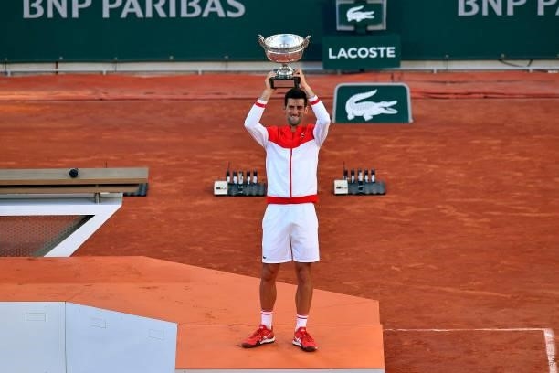 Novak Djokovic of Serbia lifts the Mousquetaires trophy after winning his Men's Singles Final match against Stefanos Tsitsipas of Greece during Day...