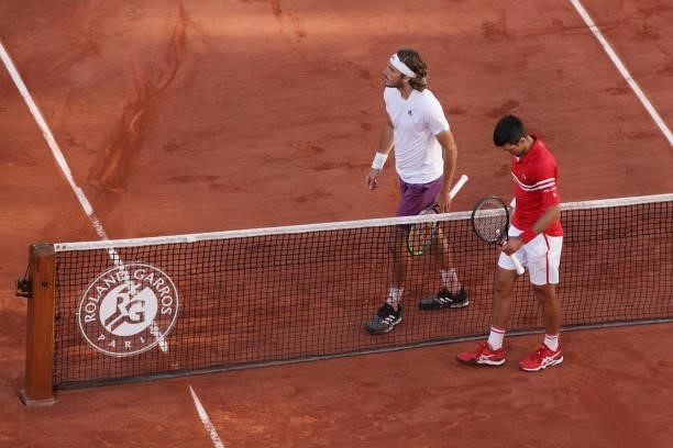 Winner Novak Djokovic of Serbia and runner-up Stefanos Tsitsipas of Greece react after shaking hands at the net in their Men's Singles Final match...