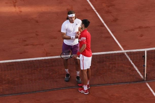 Runner-up Stefanos Tsitsipas of Greece and winner Novak Djokovic of Serbia shake hands at the net after their Men's Singles Final match during Day...