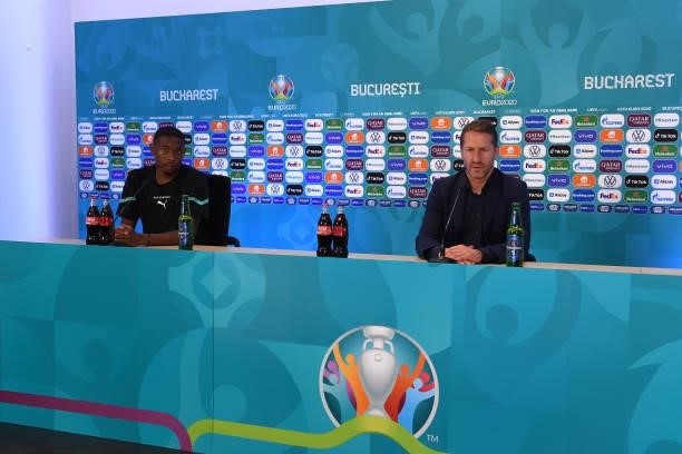 In this Handout picture provided by UEFA, David Alaba of Austria and Franco Foda, Head Coach of Austria speak to the media during the Austria Press...