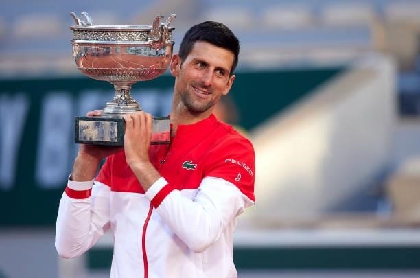 Novak Djokovic of Serbia celebrates as he lifts the trophy after winning in his Men's Singles Final match against Stefanos Tsitsipas of Greece during...
