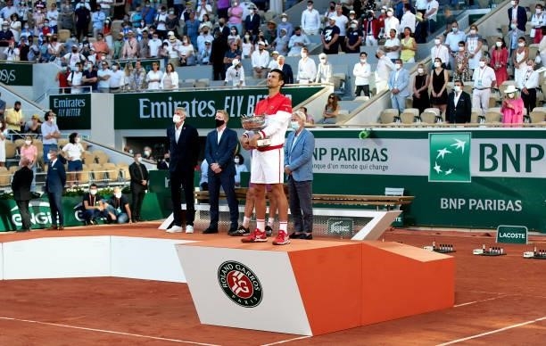 Novak Djokovic of Serbia celebrates as he holds the trophy after winning in his Men's Singles Final match against Stefanos Tsitsipas of Greece during...