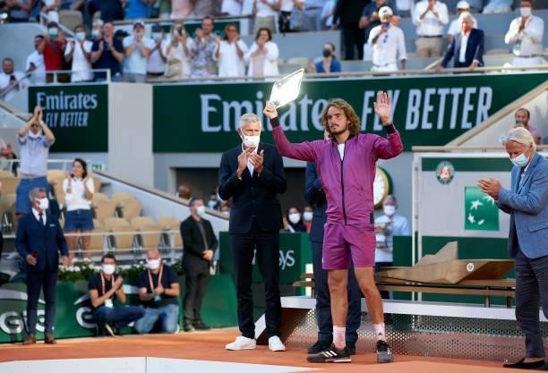 Stefanos Tsitsipas of Greece lifts his trophy after loosing in his Men's Singles Final match against Novak Djokovic of Serbia during day fifteen of...
