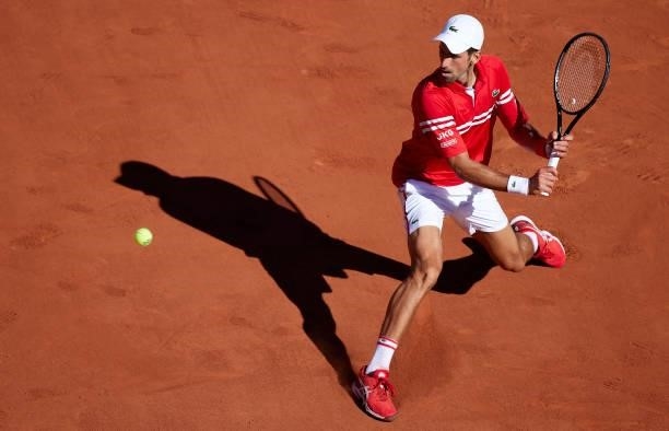Novak Djokovic of Serbia plays a backhand shot in his Men's Singles Final match against Stefanos Tsitsipas of Greece during day fifteen of the 2021...