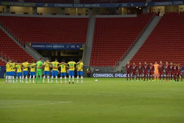 Players of Brazil and Venezuela observe a minute of silence in honor to victims of COVID-19 before a Group B match between Brazil and Venezuela as...