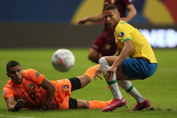 Joel Graterol goalkeeper of Venezuela and Richarlison of Brazil look at the ball during a Group B match between Brazil and Venezuela as part of Copa...