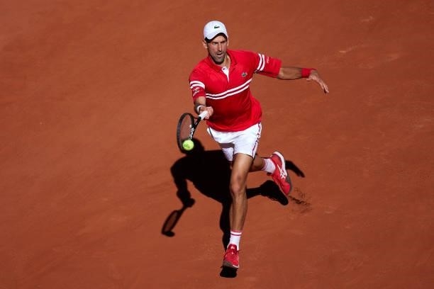 Novak Djokovic of Serbia returns a ball in his Men's Singles Final match against Stefanos Tsitsipas of Greece during day fifteen of the 2021 French...