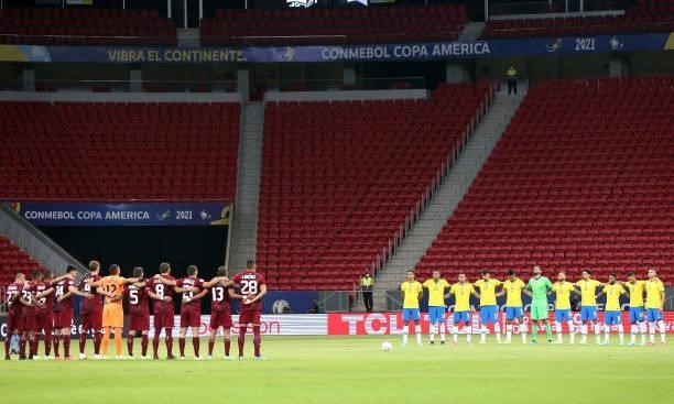Players of Brazil and Venezuela observe a minute of silence in honor to victims of COVID-19 before a Group B match between Brazil and Venezuela as...