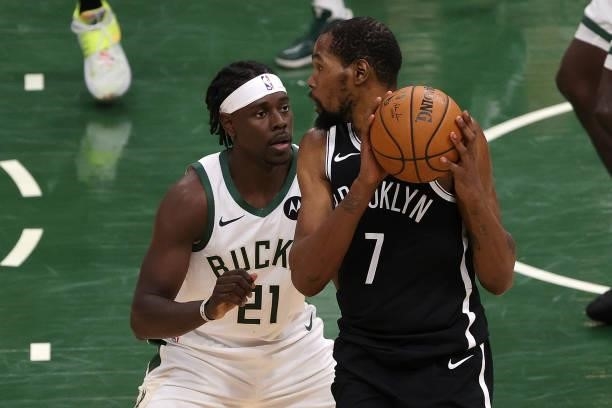 Kevin Durant of the Brooklyn Nets is defended by Jrue Holiday of the Milwaukee Bucks during the second half of Game Four of the Eastern Conference...