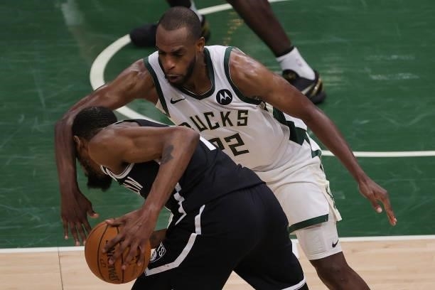 Kevin Durant of the Brooklyn Nets is fouled by Khris Middleton of the Milwaukee Bucks during the second half of Game Four of the Eastern Conference...
