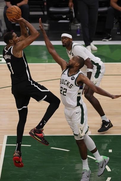 Kevin Durant of the Brooklyn Nets shoots over Khris Middleton of the Milwaukee Bucks during the second half of Game Four of the Eastern Conference...