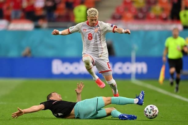 Egzijan Alioski of North Macedonia is challenged by Stefan Lainer of Austria during the UEFA Euro 2020 Championship Group C match between Austria and...