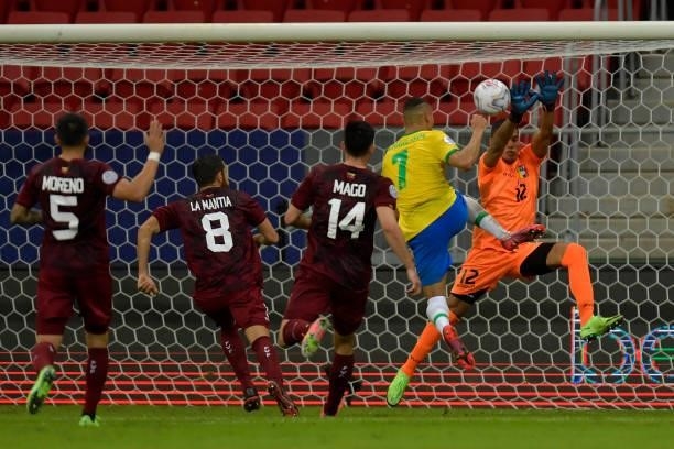 Joel Graterol goalkeeper of Venezuela makes a save against Richarlison of Brazil during a Group B match between Brazil and Venezuela as part of Copa...