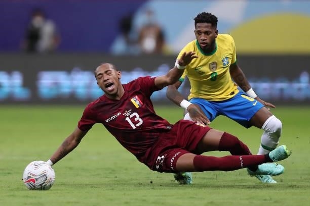 Jose Martinez of Venezuela competes for the ball with Fred of Brazil during a Group B match between Brazil and Venezuela as part of Copa America 2021...